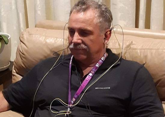 what happens during a neuroptimal session, photorealistic, calming office setting with plants, highly detailed, gentle gestures, warm muted tones, soft ambient lighting, shot with a 50mm lens.